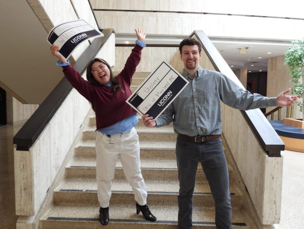 Students celebrating their matches in academic lobby
