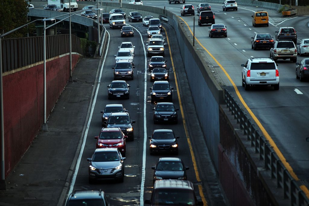 Cars traveling on a highway in the early morning light.