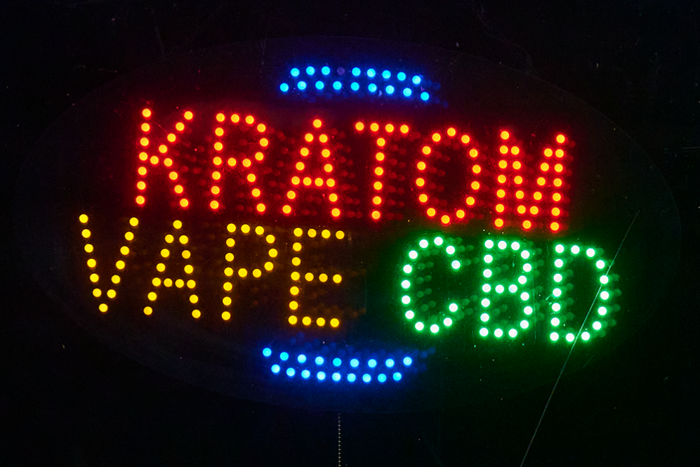 Dotted neon sign that reads: KRATOM VAPE & CBD