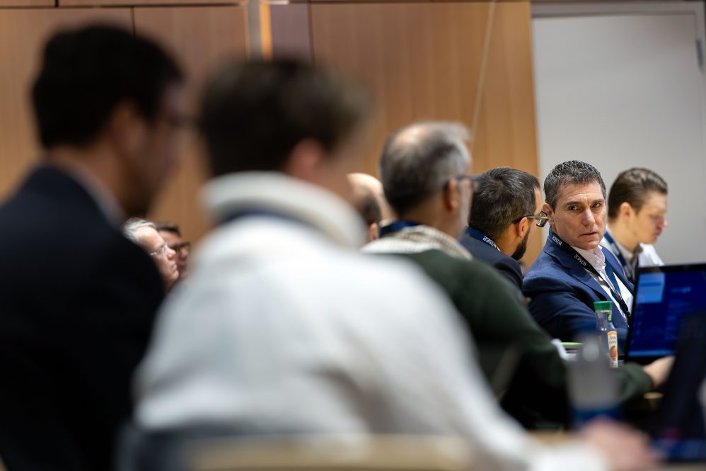 A group of men attending a lecture event