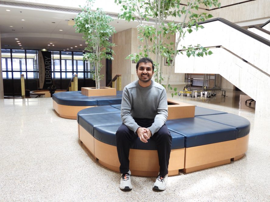 The future Dr. Parth Patel SOM Class of 2026 in Academic lobby sitting.