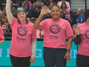two women waving to the crowd