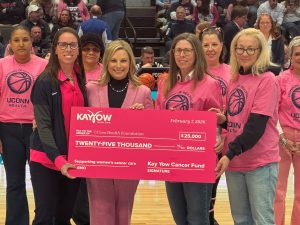 4 women holding a big pick check.