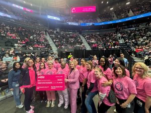 large group of women wearing pink shirts