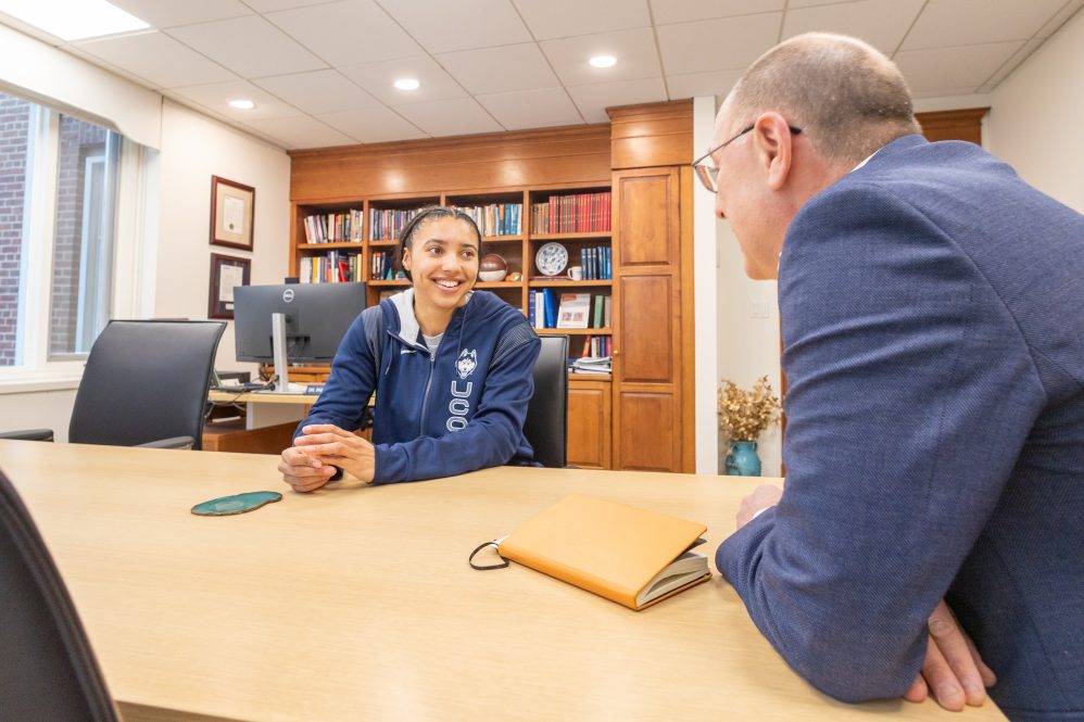 Two people sitting at a table having a discussion