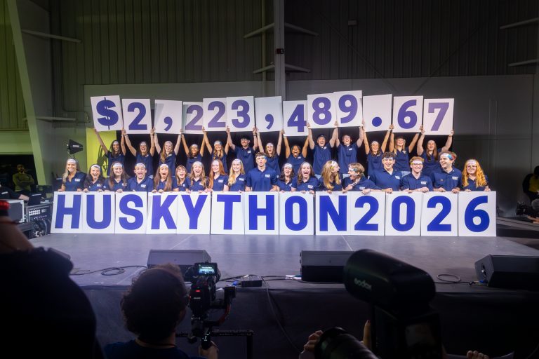 The HuskyTHON management team reveals the final total for the 2026 iteration of the dance marathon, $2,223,489.67, onstage