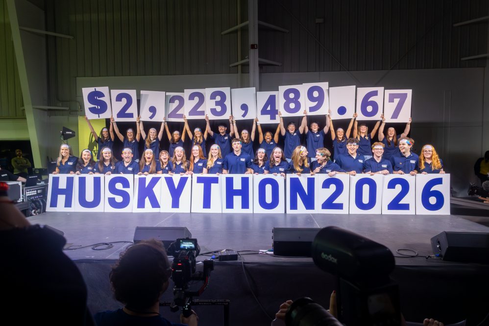 The HuskyTHON management team reveals the final total for the 2026 iteration of the dance marathon, $2,223,489.67, onstage