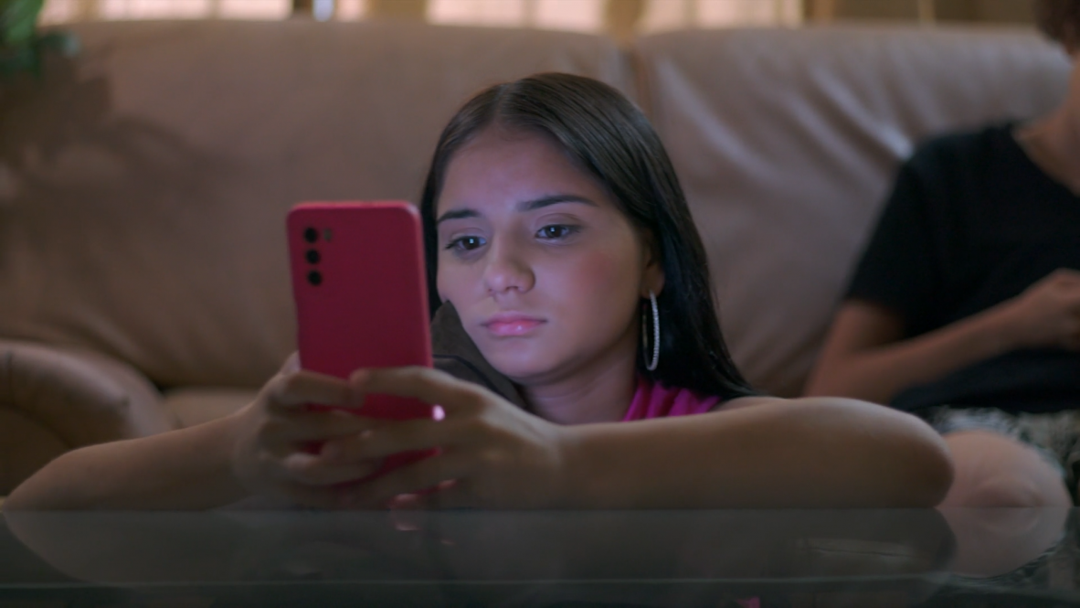 Teenage girl looking at her phone.