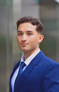 Lucas Ruiz wearing a blue suit and tie.
