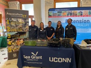 Four staff from CT Sea Grant stand by their table at Ag Day at the Capitol