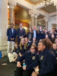 A group of UConn and CT government leaders stand with FFA students