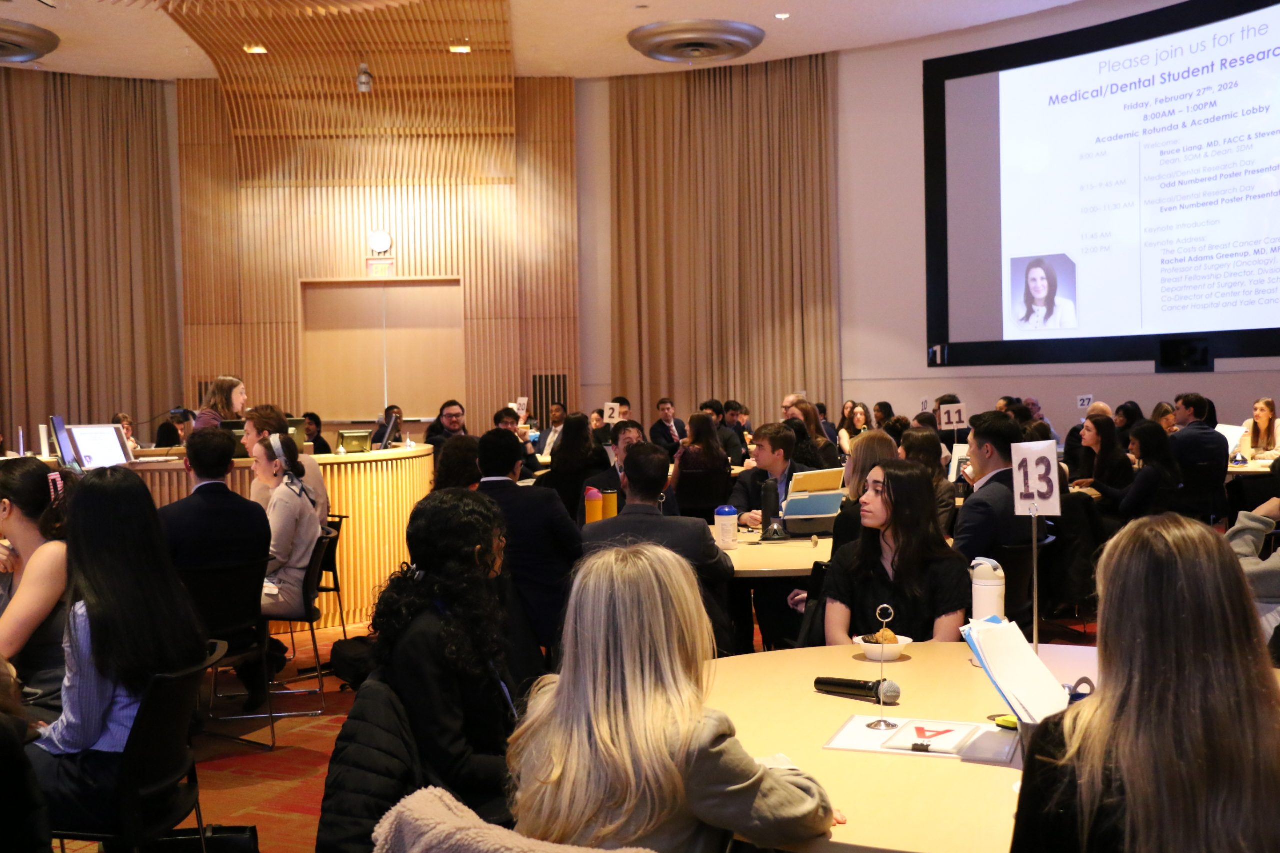 woman speaking to audience of students