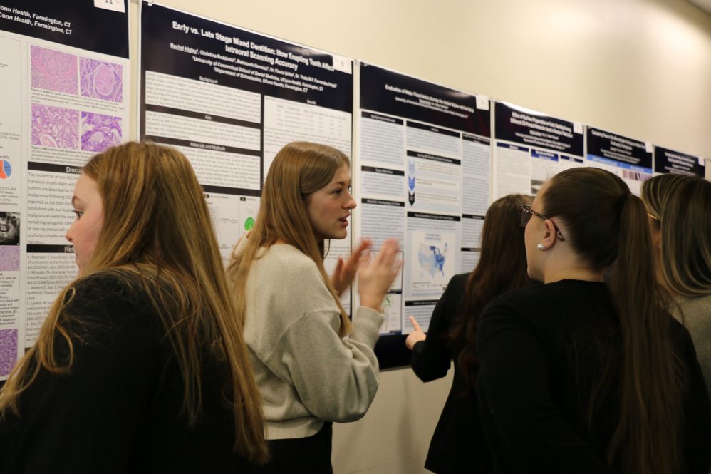 students presenting research posters