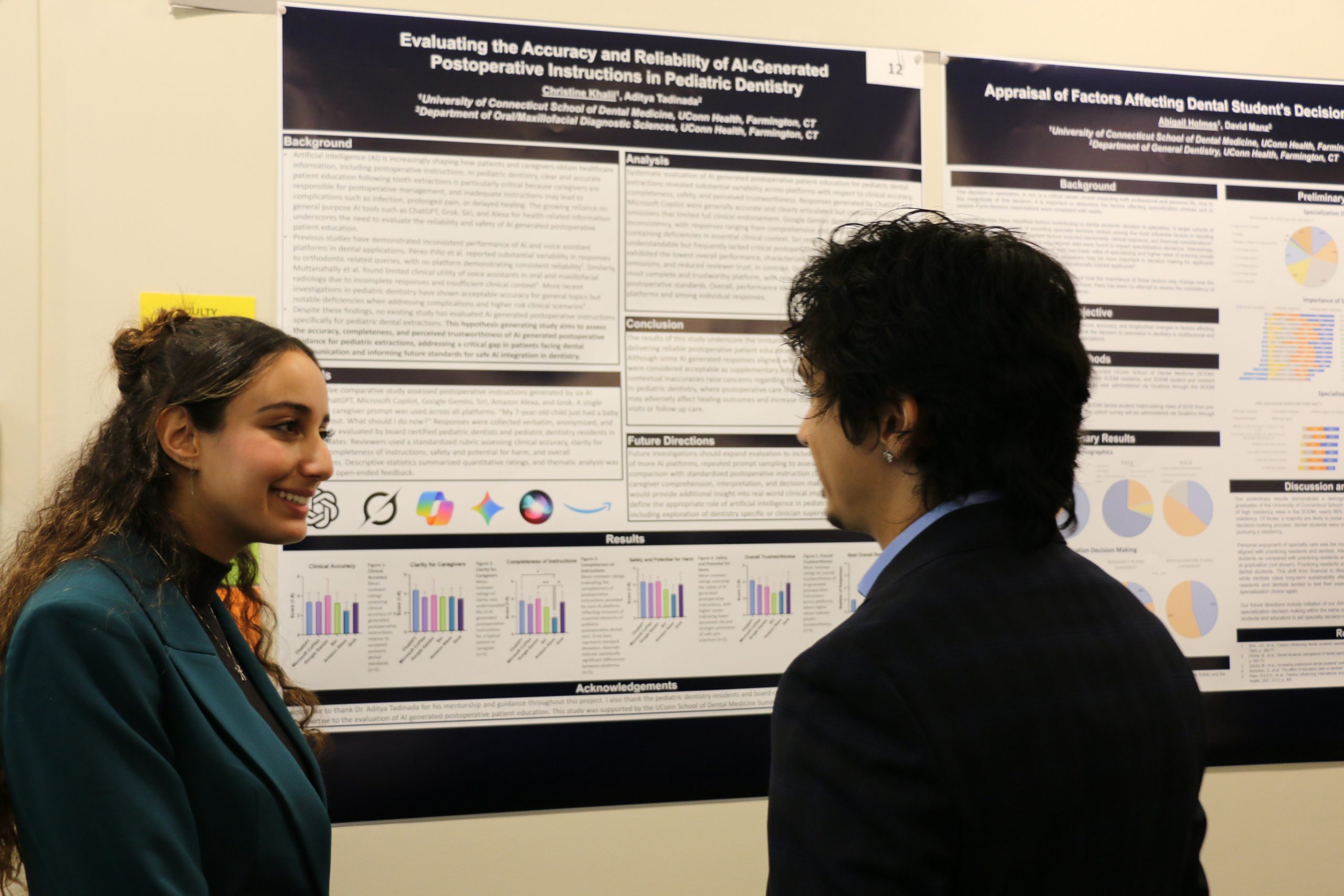 two students in front of research poster