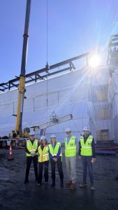 UConn Nursing Dean and construction workers for DeLuca Hall with the signed beam.