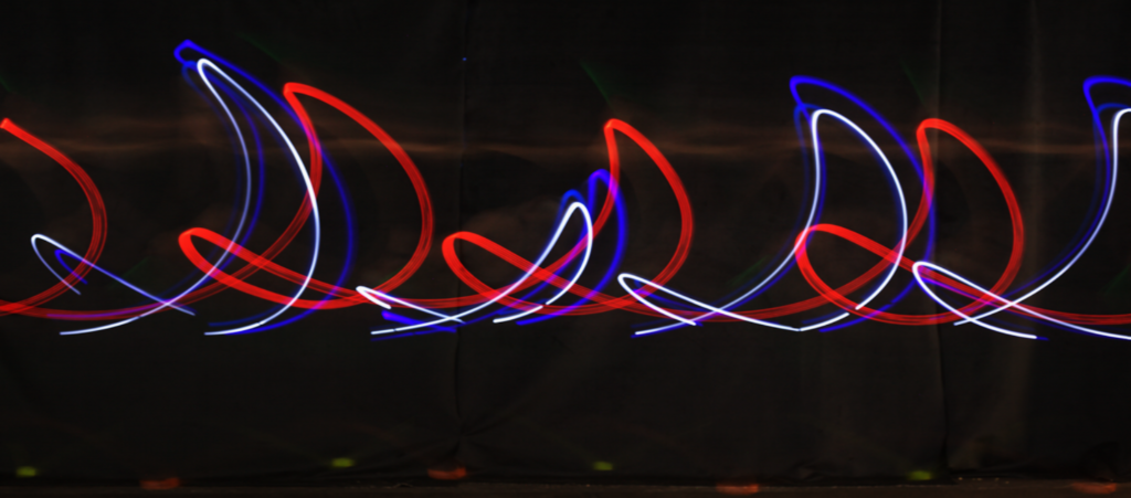 Whorls of colorful light against a black backdrop