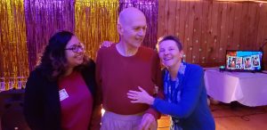 A woman with glasses and black hair poses for a headshot photo