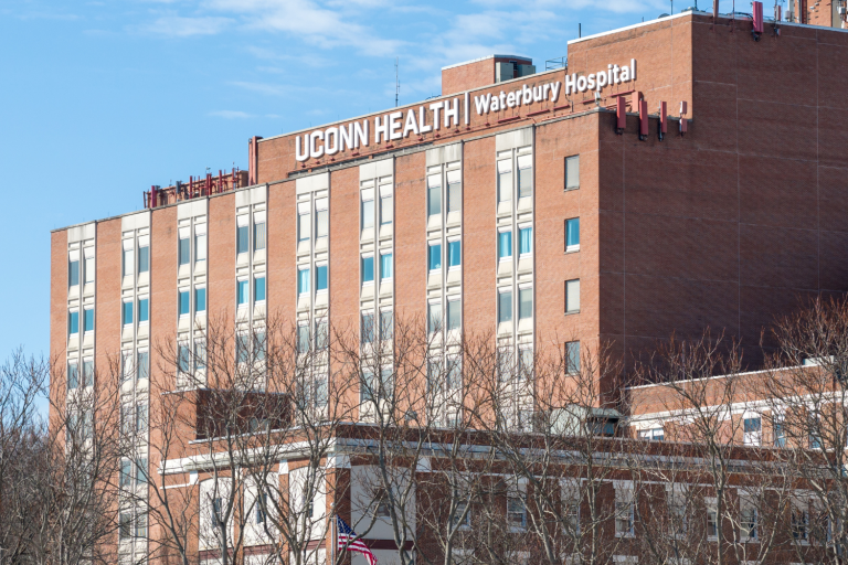 Brick building with signage that says UConn Health Waterbury Hospital