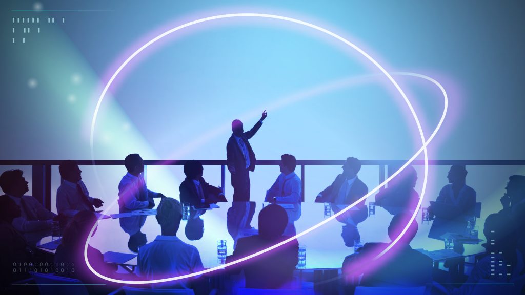 Business people sitting in a dark room with abstract circular shapes superimposed over the image.