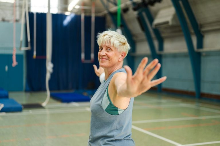 Smiling older woman exercising in a gymnasium