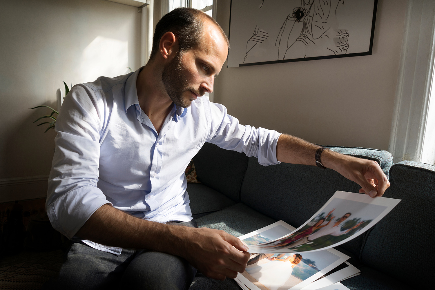 man looking at photographs