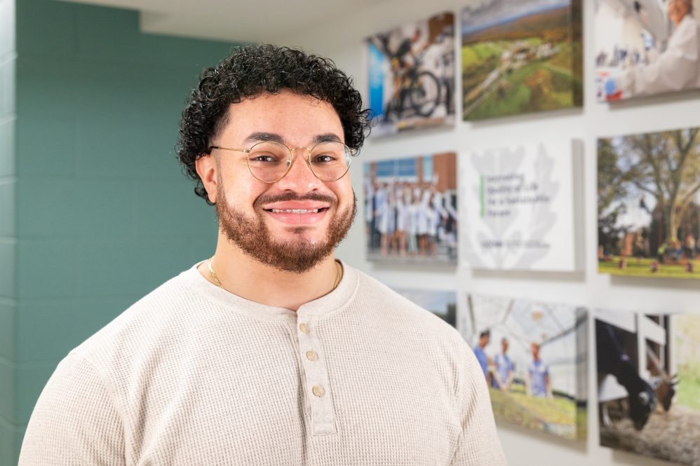 A man with glasses standing in a building for a portrait