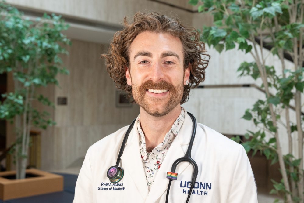 A man in a white lab coat and a stethoscope around his neck