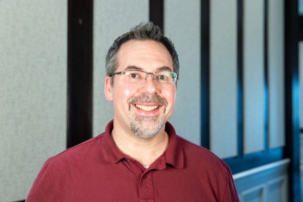 A man in glasses posing for a photo