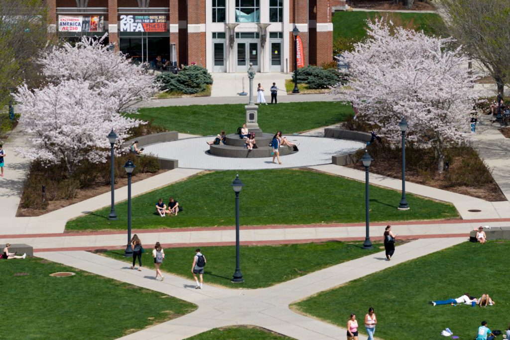 An aerial shot of sidewalks and cherry blossom trees linking the walkway