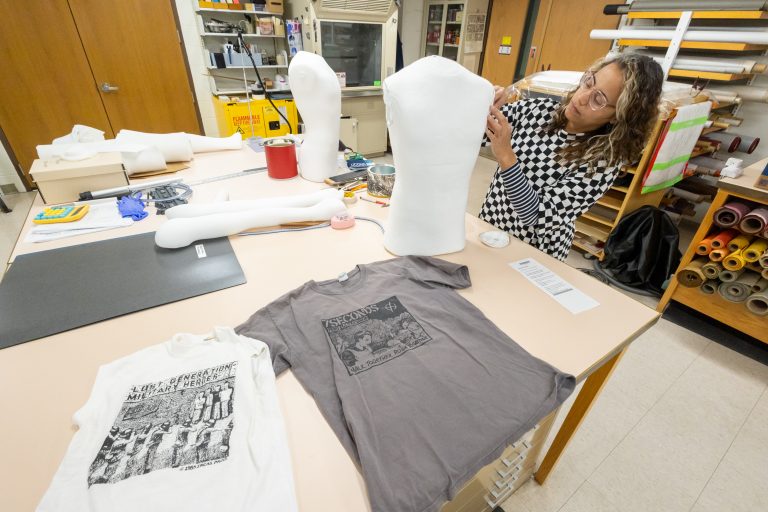 A woman working on a mannequin