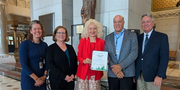 Portrait of 5 including President Maric and John Lombardi accepting GreenerGov recognition