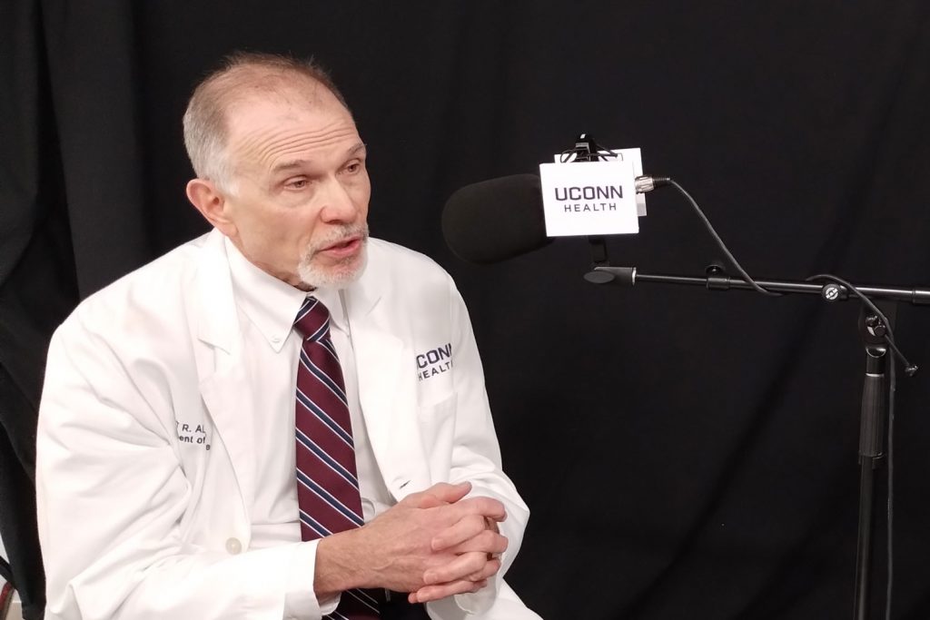 Dr. Scott Allen speaking at microphone in podcast studio