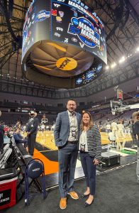 portrait man and woman on sideling of basketball court