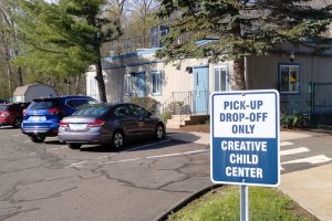 exterior shot of Creative Child Center with parked cars license plates blurred