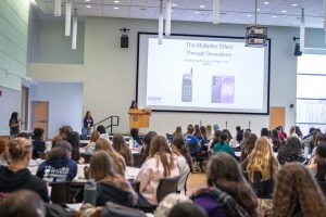 A crowded room of middle school-aged girls attending a conference.
