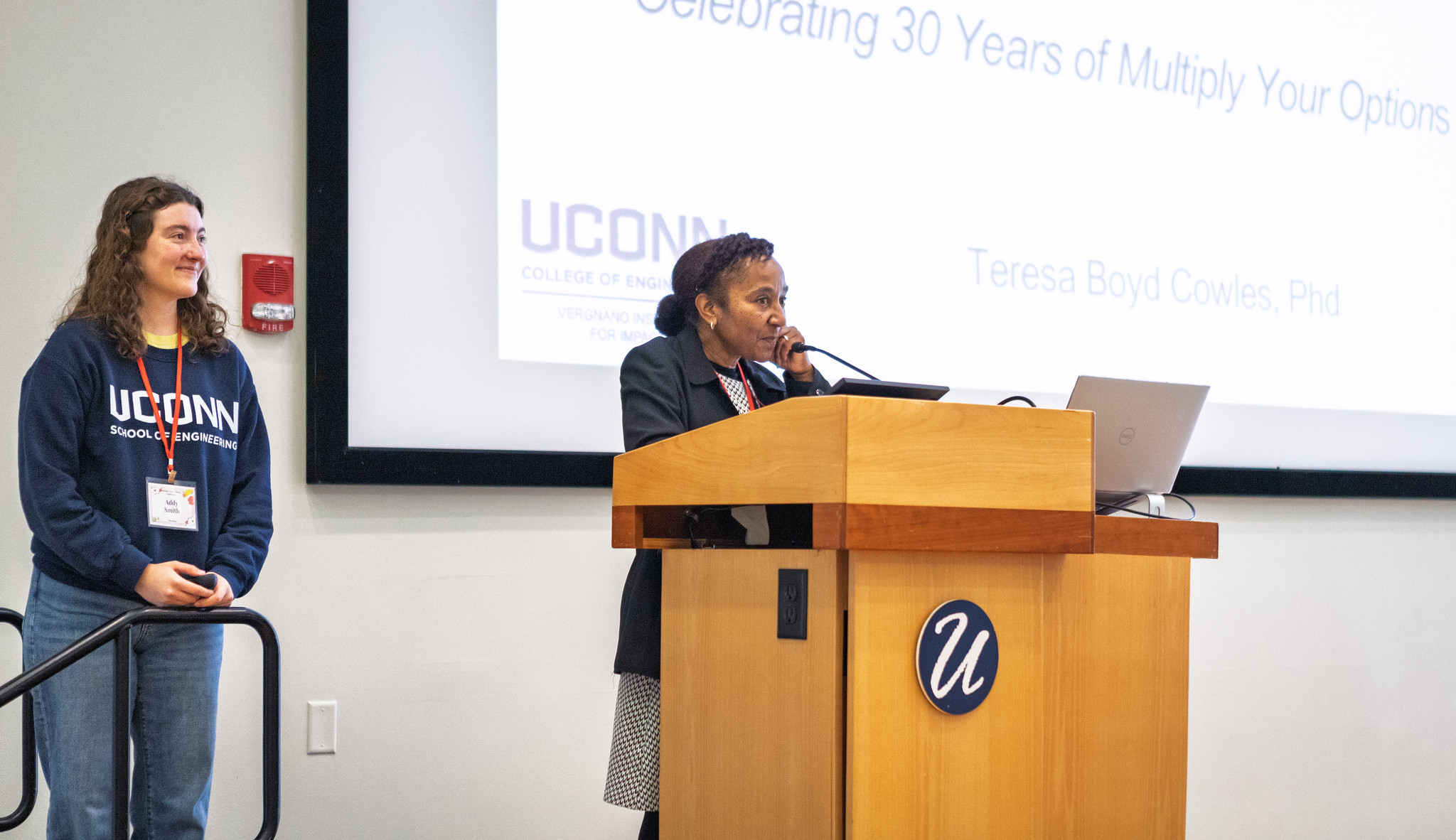 Two women presenting at a podium.