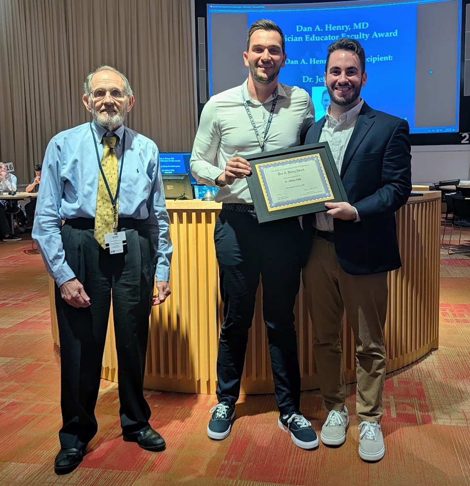 Dr. Jeffrey Pella (center) accepting the Dan A. Henry, MD Clinician Educator Faculty Award.