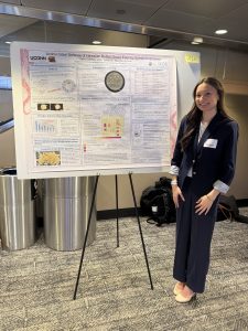 Hailey DeWalt standing in front of her research poster