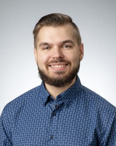 Brown haired man in blue dress shirt