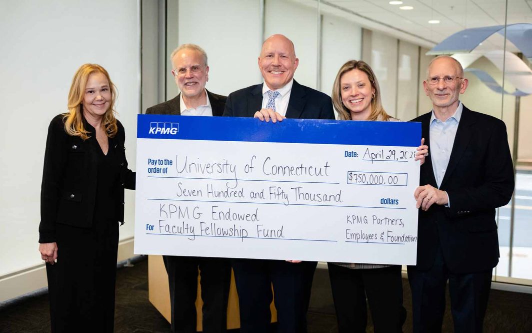 Five people pose with an oversized check at the GBLC in Hartford, CT.