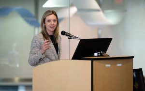 Alumna Kristen Ortuso '07, '08 MSA addresses an audience from a podium
