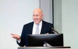 Accounting professor George Plesko making remarks at a podium.