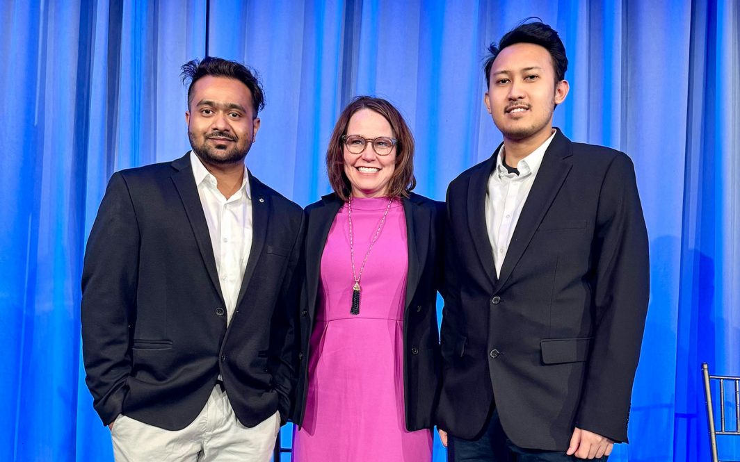 UConn Grad students Trishan Kundu and Vitosavero Avila Wibisono pose for a photo with an executive from Principal Insurance at the InsurTech NY University Competition.