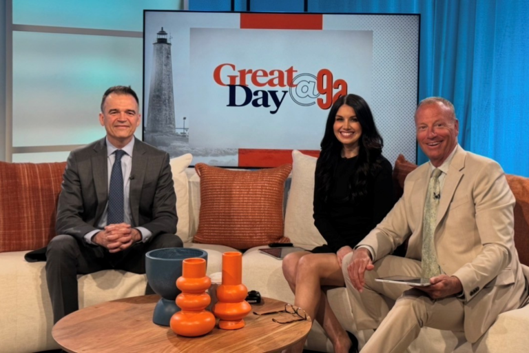 Two men and a woman sitting on a couch