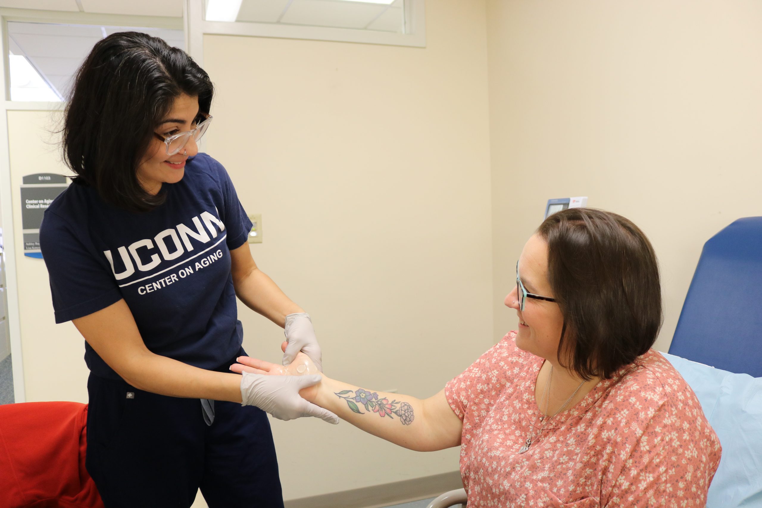 New skin patch in clinical studies in action being placed by the UConn Center on Aging study coordinator Alba Santiago at the UConn Center on Aging.