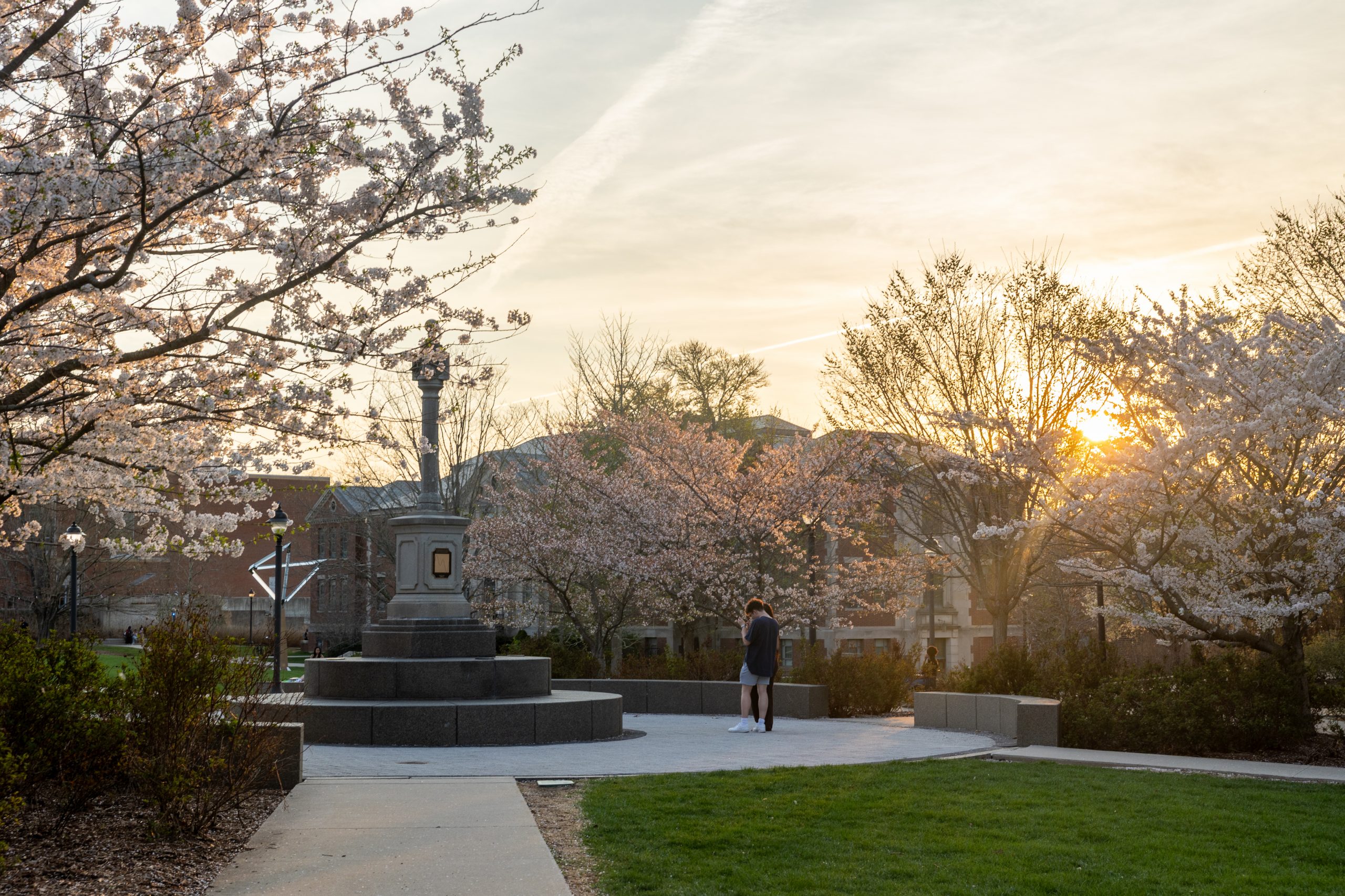Sunset on campus with spring blooms and a sundial