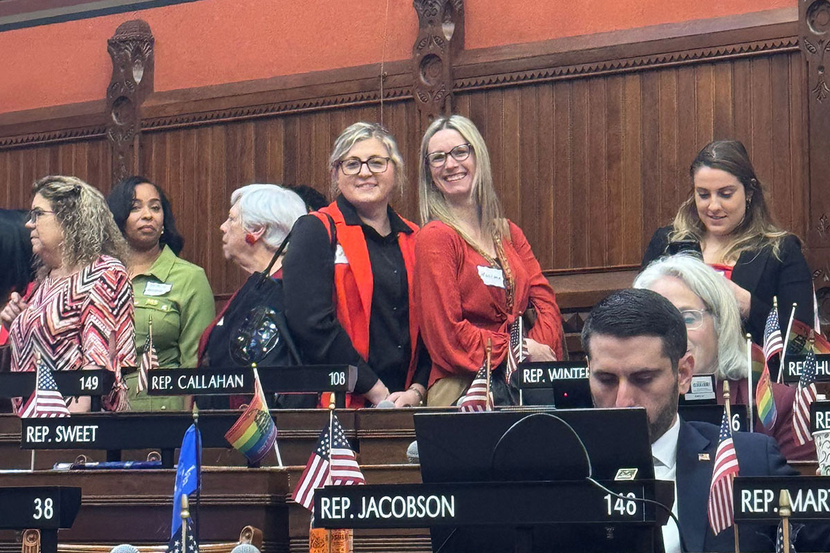 portrait two women wearing red in sate House chamber