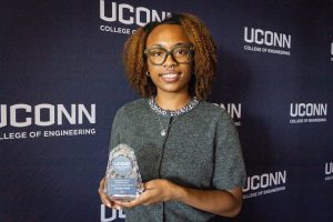 A woman holding an award.