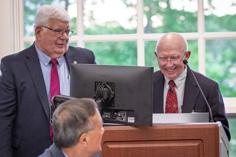 Two men standing at a podium.