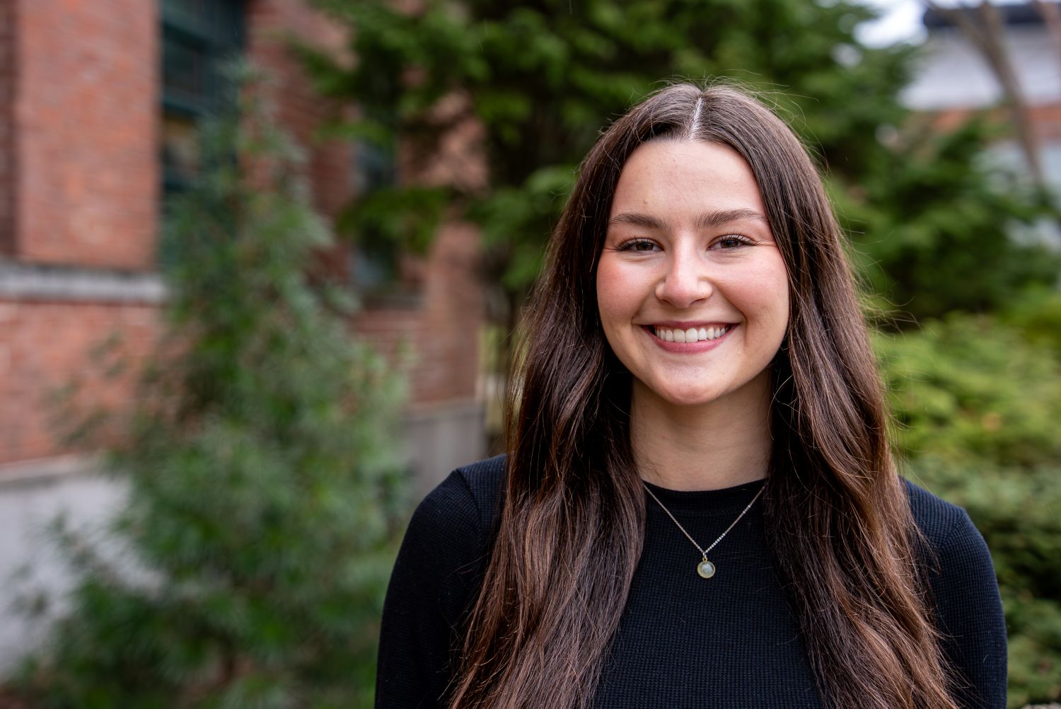 Jacqueline Baron ‘26 (CAHNR), a natural resources major poses for a photo outside the Wilfred B. Young Building (YNG)